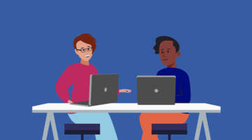 two people talking at a desk