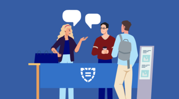 People conversing at a display table
