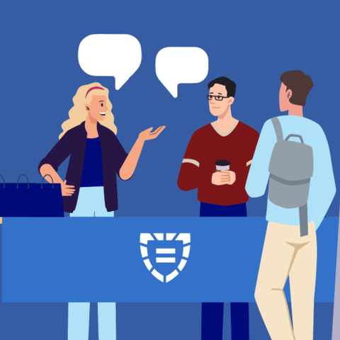 People conversing at a display table