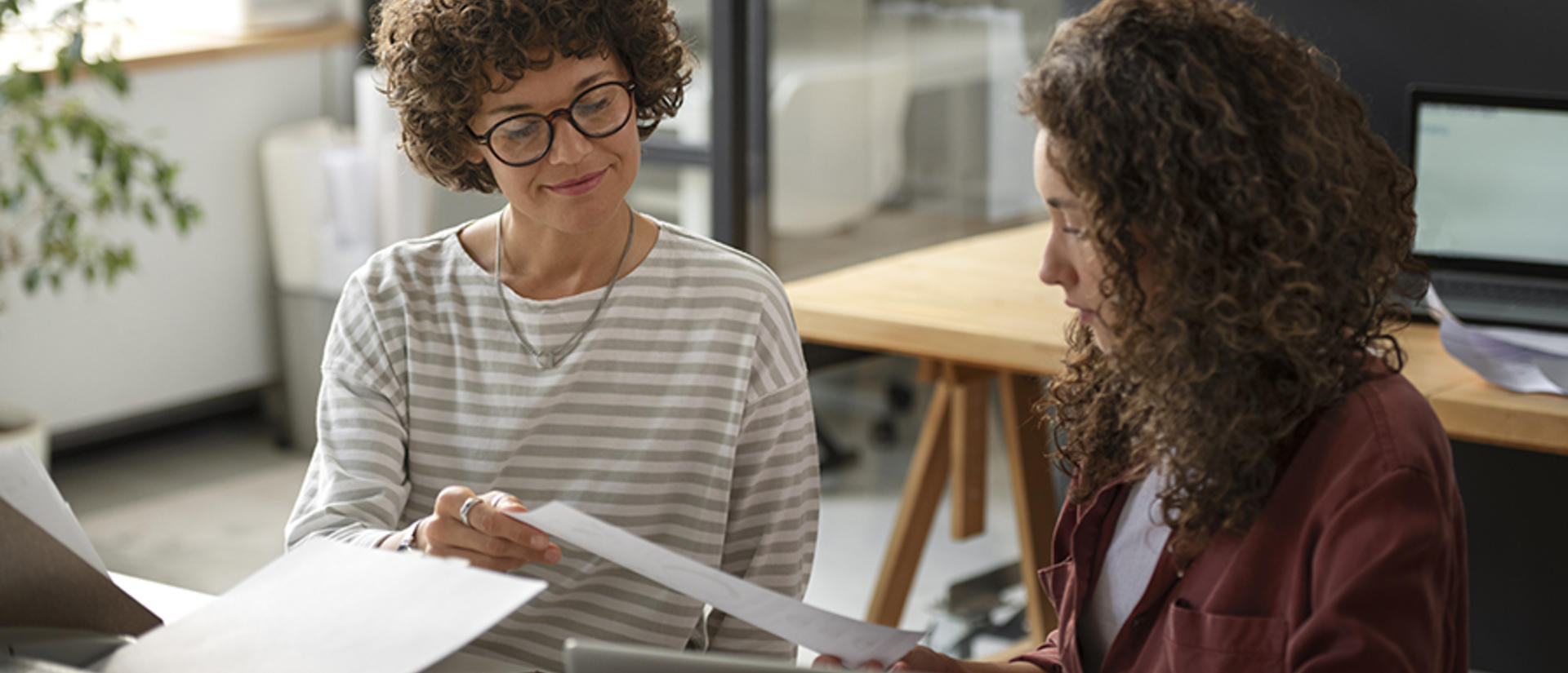 Two people chatting at a desk